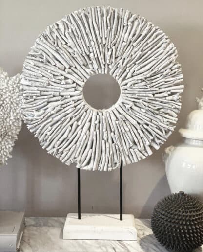 white rustic round twig disc on a wooden stand